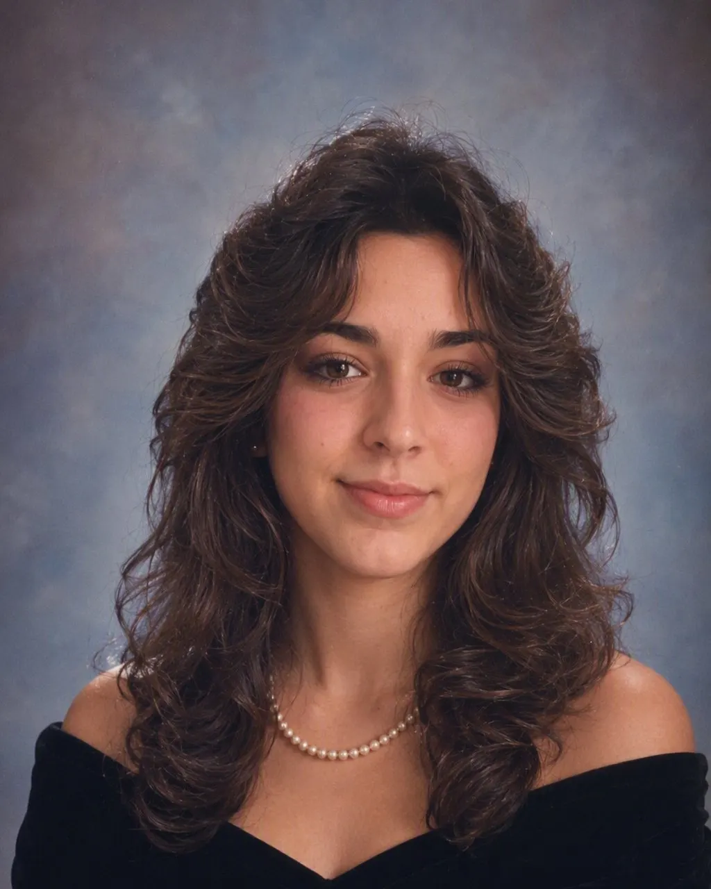A portrait restyled as a mid-80s senior picture with big hair, a soft studio flash and a mottled backdrop, made with FaceCast
